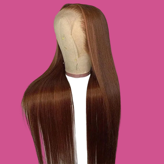 Brown wig on a mannequin head against a white background