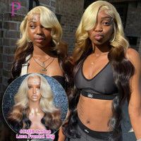Woman with blonde and black ombre lace frontal wig in front of a brick wall.