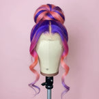 Multicolored wig on a mannequin head with a blurred indoor background